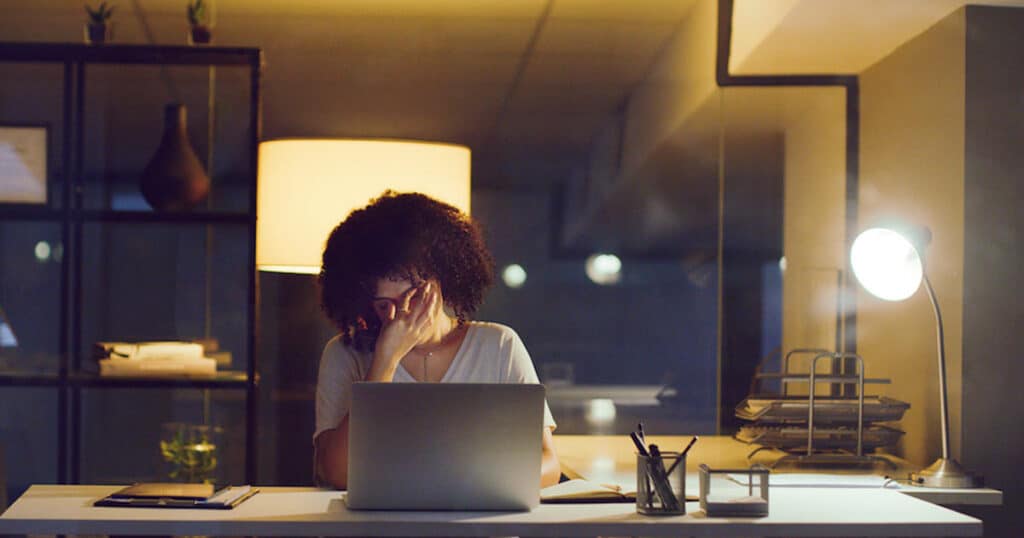 woman burned out at desk