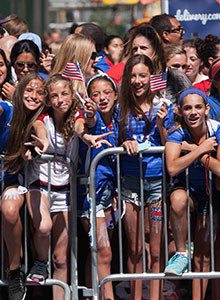Fans cheer on the U.S. women's soccer team at the first ticker-tape parade in New York City for an all-female sports team. Photo credit: Anthony Quintano