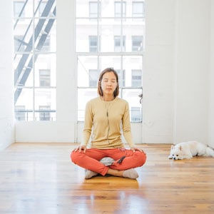Yunha Kim meditating in a white room