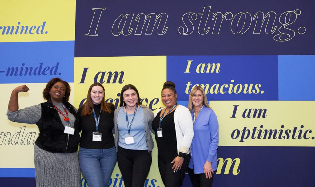 attendees posing for a group photo at the MA Conference for Women