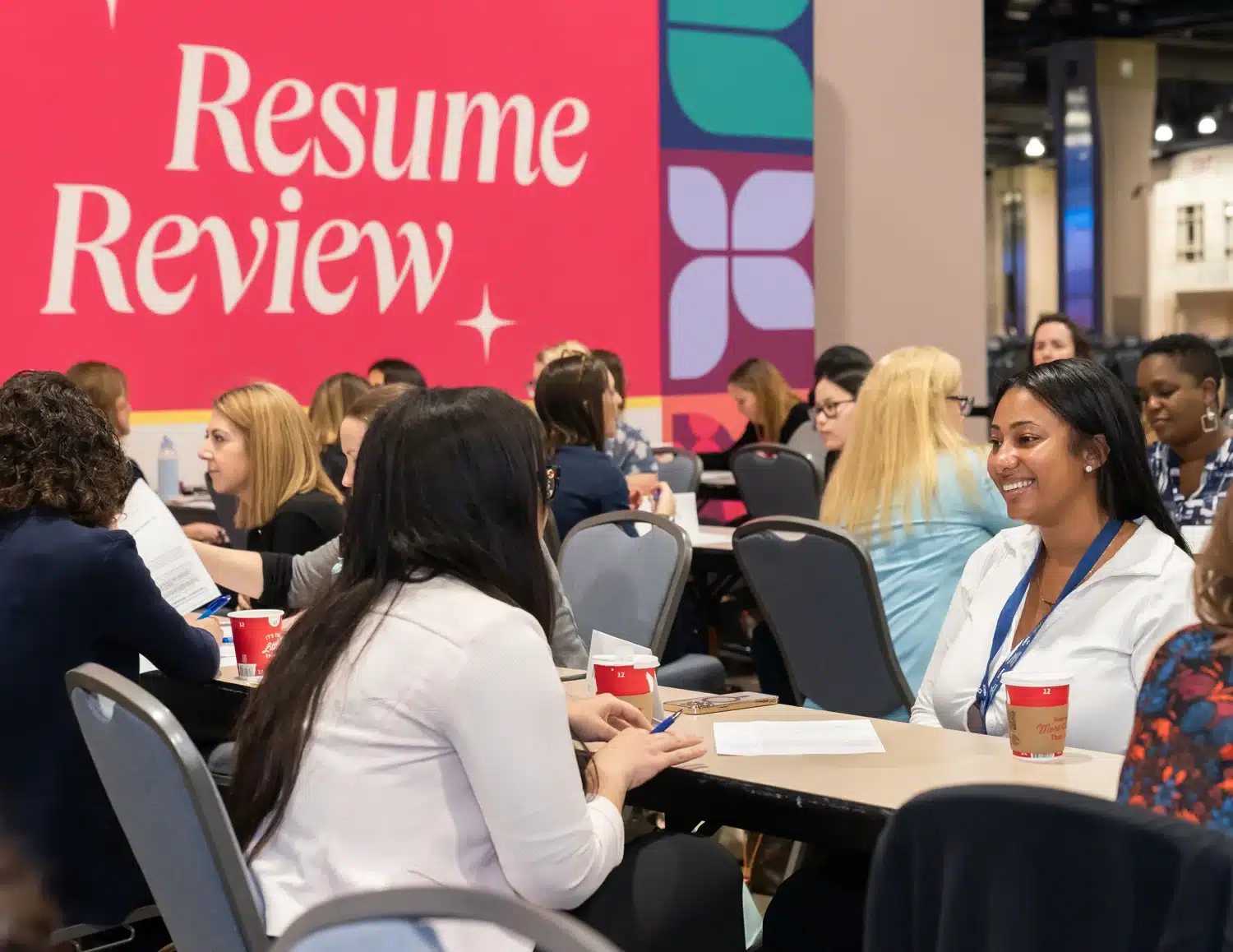 Conference for Women attendees receiving resume review services